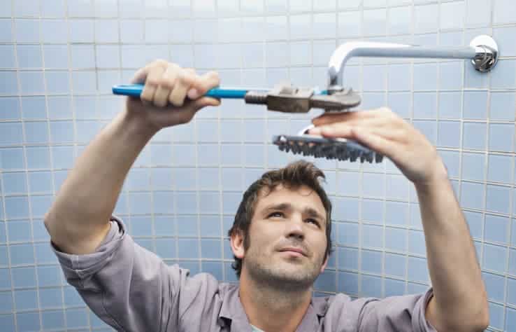 Plumber working on shower head