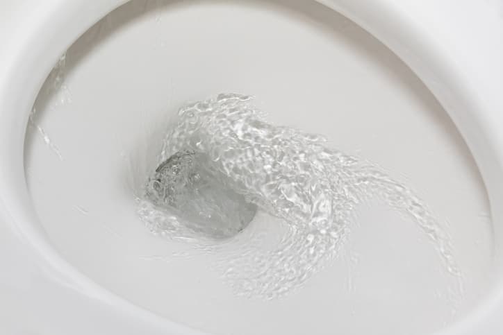 Clean toilet bowl with water flushing 