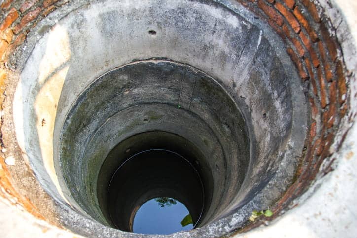 an upclose photo looking down from the top of a well.