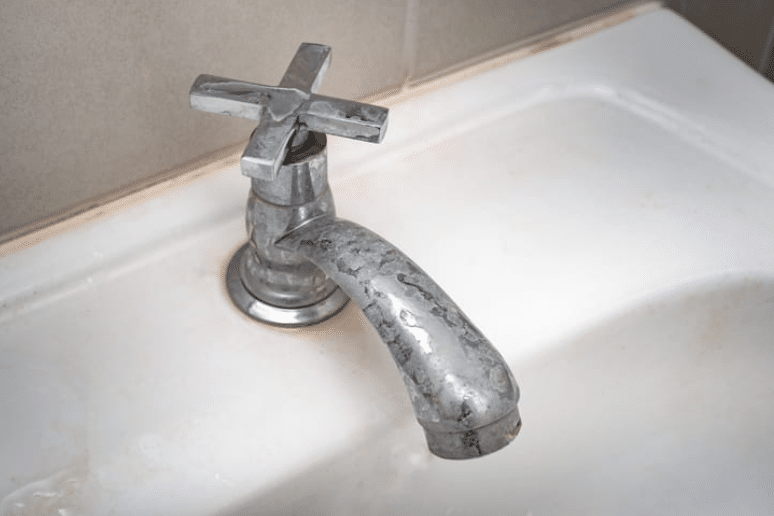 Evidence of hard water on a bathroom faucet. 