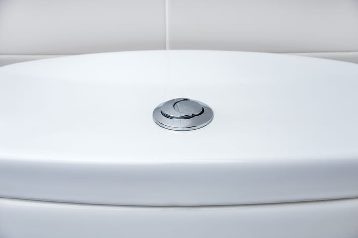 A toilet tank with two flushing options.