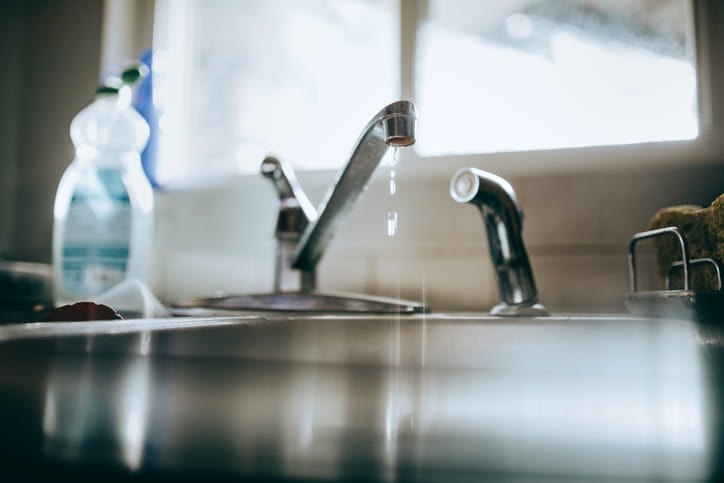 A dripping faucet from a kitchen sink. 